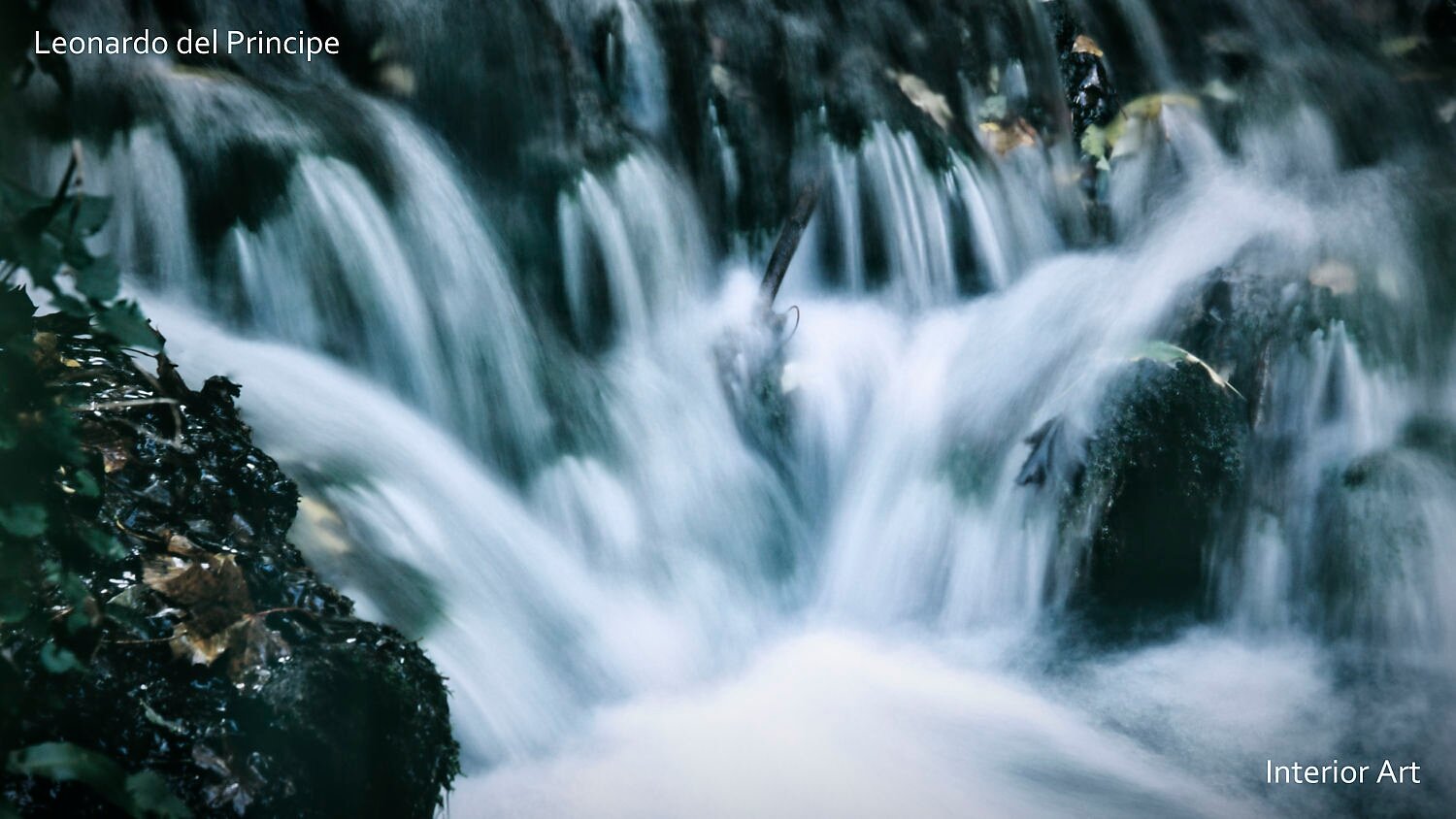 KOSA04 A serene waterfall cascades over rocks adorned with moss and leaves, creating a calming and tranquil scene with soft, blurred water movement.