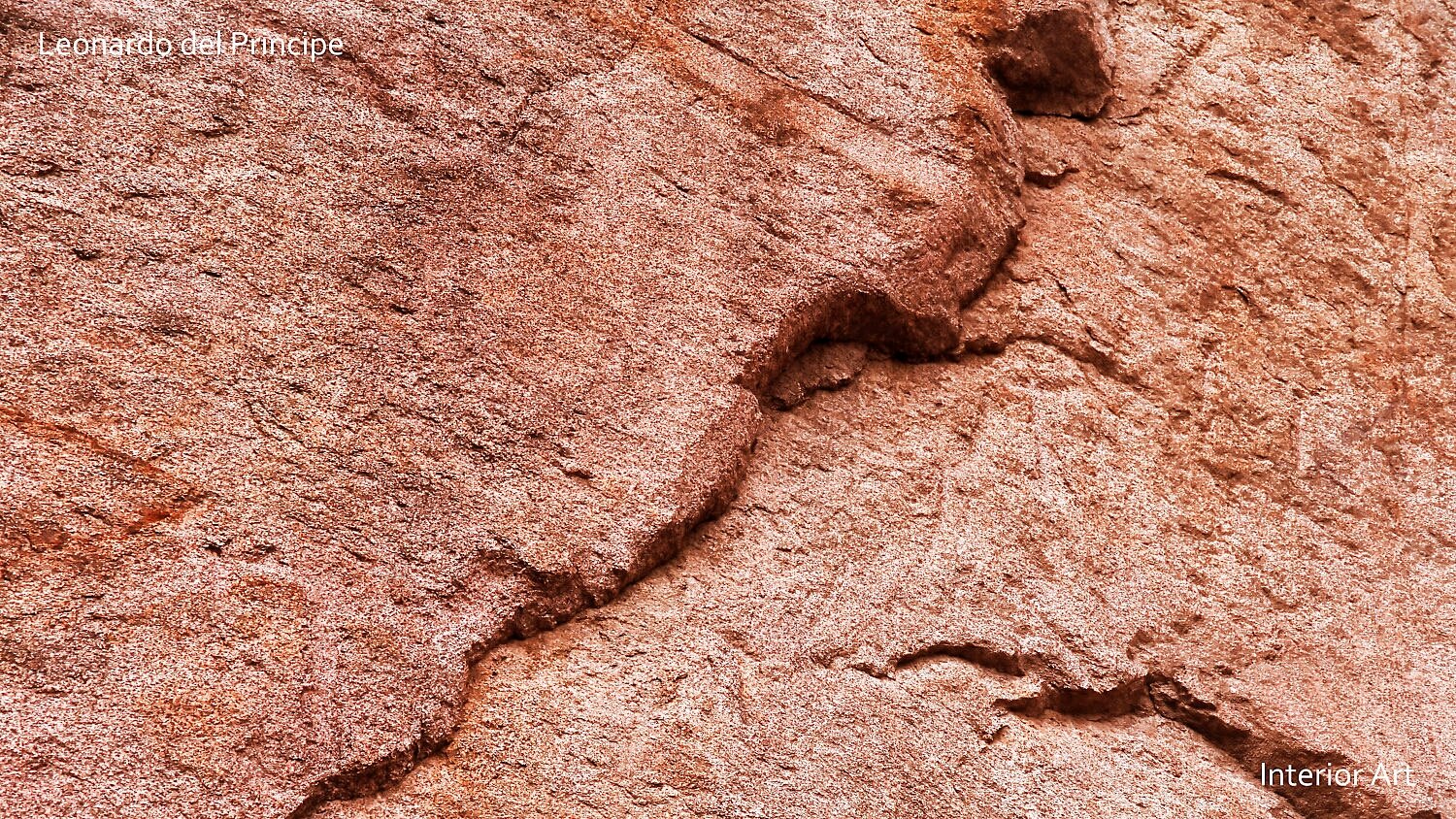 ABGR04 Close-up of a textured, reddish-orange rock surface, showing natural grooves and rough patterns. The image is abstract and evocative.