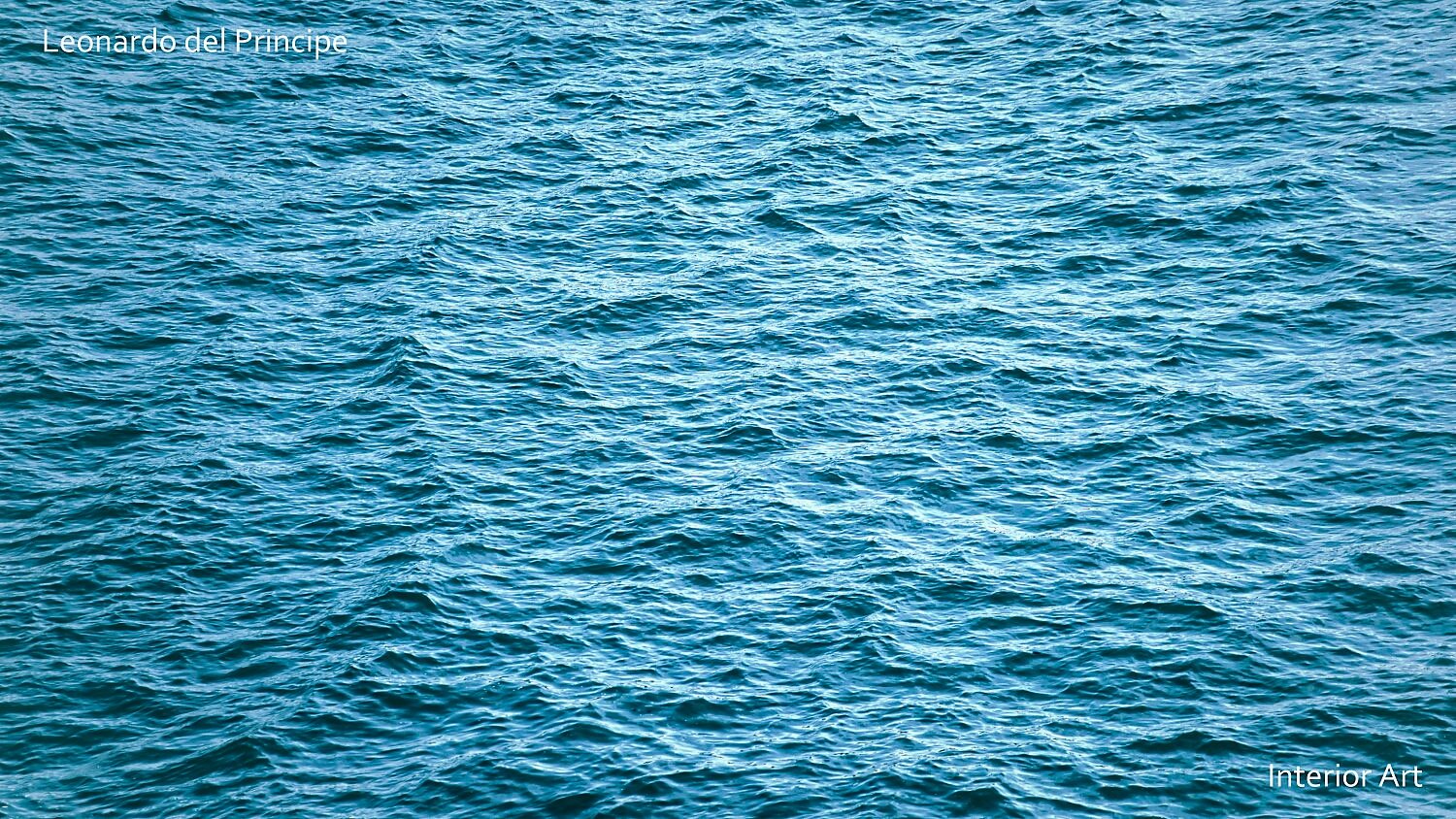 ESEAa01 Rippling blue ocean water fills the image, creating a serene and calming effect. The gentle waves and reflections under daylight convey tranquility.