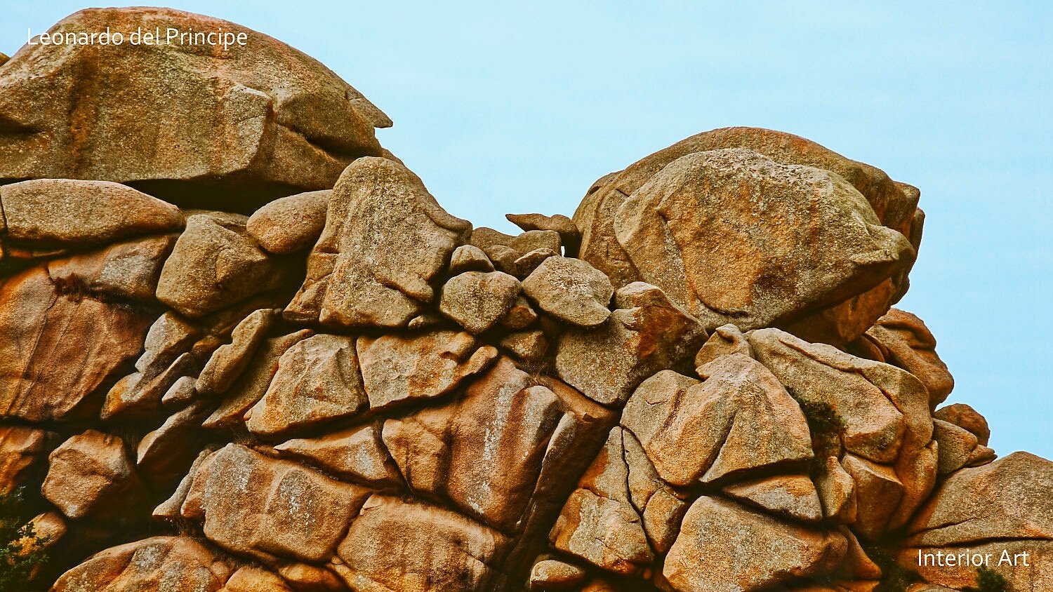 ESGR02 Rugged, weathered rock formations with varied shapes and textures set against a clear blue sky. The scene evokes a sense of timeless natural beauty.