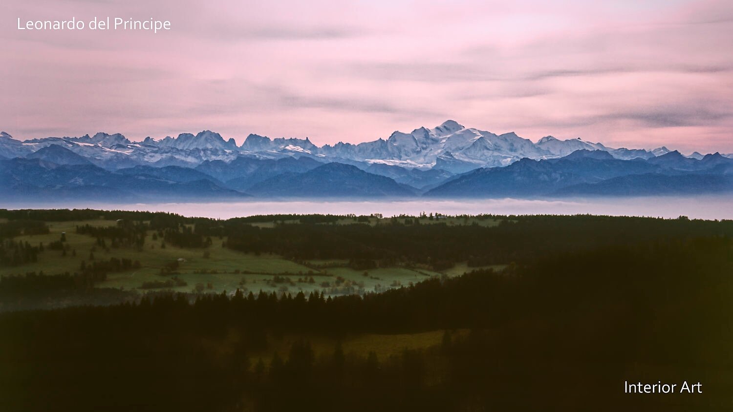HBSD01 A serene landscape with snow-capped Mont-Blanc under a soft pink sky. Misty valleys contrast with dark forested hills in the foreground.