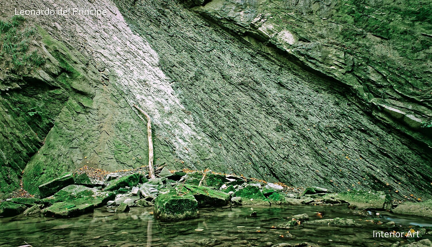 RIMOa02 A serene rock face with a slanted, mossy surface above a calm pool with scattered stones. The setting evokes a tranquil, natural atmosphere.
